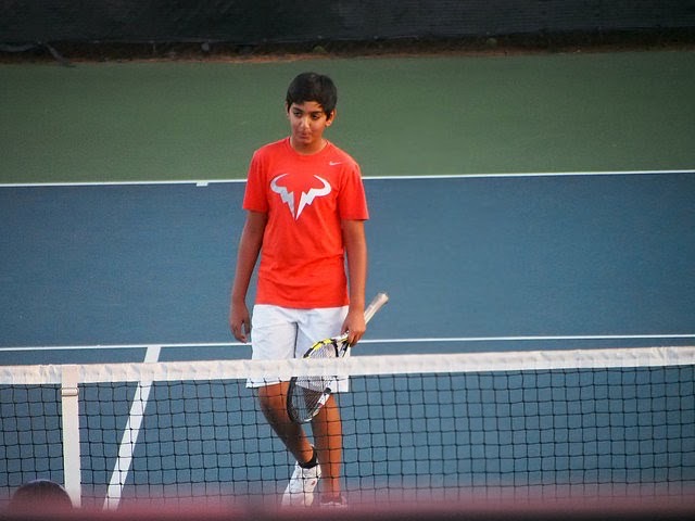 Mihir as a child wearing Nadal tennis gear.